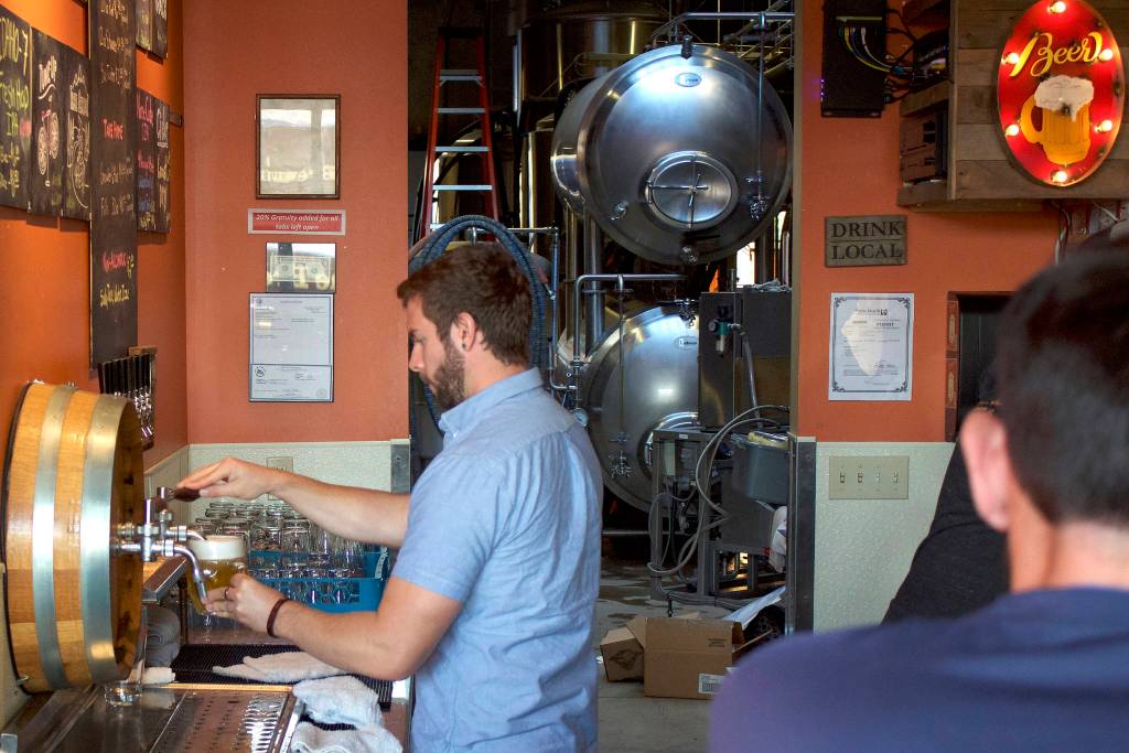 Chainline employees work a crowded tap room on a Friday night. According to Chief Hoperations Officer Scott Holm, Fridays are some of their busiest days. Kailan Manandic/staff photo