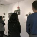 From left: Samantha Areliz (VALA curator), Marisa Mouton Provo (VALA Communication Director) and Zachary Burns (artist) look upon the Gatesville exhibit at the new VALA Eastside in Kirkland. Madison Miller/staff photo.