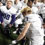 Max Earl, front left (99), listens with his teammates to Lake Washington head coach Andy Arenas postgame talk on Friday. Andy Nystrom / staff photo