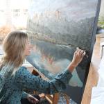 Elina Dmitruk uses Garrett Kings photo, Grand Tetons as a reference for her landscape painting at Zoka Coffee. Shes been painting this piece for about a month now. Stephanie Quiroz/staff photo