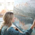 Elina Dmitruk uses Garrett Kings photo, Grand Tetons as a reference for her landscape painting at Zoka Coffee. Shes been painting this piece for about a month now. Stephanie Quiroz/staff photo