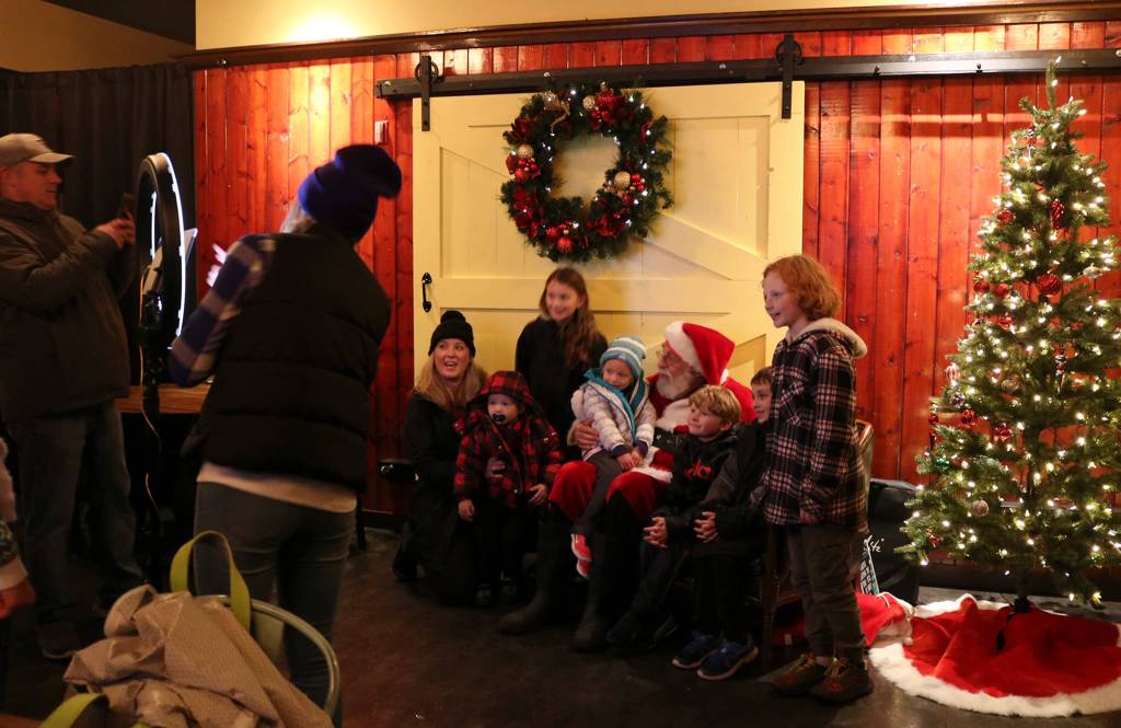 Members of the Bettes and Beecher families from Kirkland get their photo taken with Santa at the Wilde Rover during Winterfest on Dec. 1. Katie Metzger/staff photo