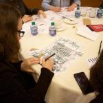 Attendees learn how to elevate seasonal gift wrapping with hand-lettered holiday cards. Stephanie Quiroz/staff photo