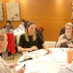 Attendees at a hand lettering class at The Heathman Hotel in Kirkland on Dec. 9, taught by Camille Robinson of Robinson Paperie, practice their newly acquired skills. Stephanie Quiroz/staff photo