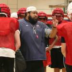 Lele Teo leads the Juanita High football squad through practice in August. Reporter file photo