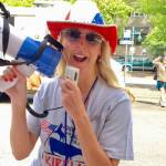 Barbie Young brings the energy with a megaphone at a Kirkland Downtown Association event. Photo courtesy of Barbie Young.