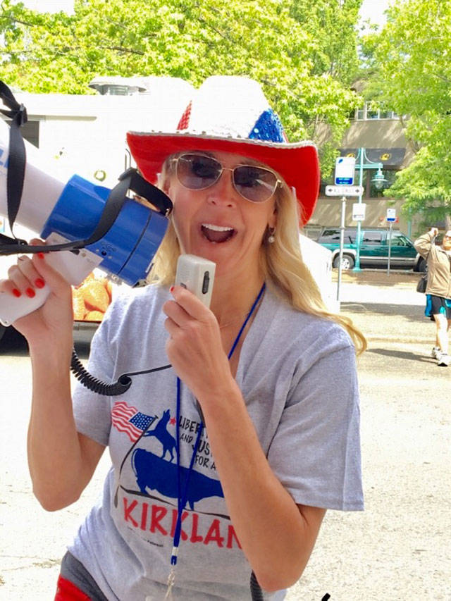 Barbie Young brings the energy with a megaphone at a Kirkland Downtown Association event. Photo courtesy of Barbie Young.