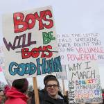 Young boy carries a sign that reads, Boys will be good humans. Stephanie Quiroz/staff photos