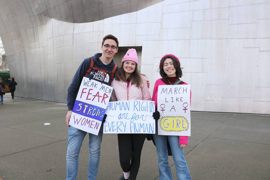 From left, Woodinville residents Miles Vernasco, Kendra Housough, and Lily Pilewood attended the Womxns March on Jan. 19.