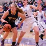 Bellevue Wolverines senior team captain Ali Jochums, left, gains possession of the ball in the paint while being covered by Lake Washington sophomore forward Brooke Filan. Lake Washington defeated Bellevue 57-37 on Jan. 23 in Kirkland. Photo courtesy of Stephanie Ault Justus