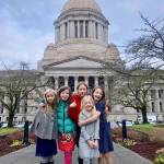 The Straw Girls smile in front of the Washington State Capitol building in Olympia. Photo courtesy of Angela Pifer