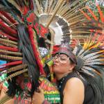 Samantha Pak/staff photo                                Two indigenous performers embrace during a break in their dancing in Plaza Coyoacán in Mexico City.