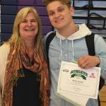 Lake Washington High principal Christina Thomas presents Kang senior Brady Gockel with his certificate of recognition from the Washington Interscholastic Activities Association as the Student-Athlete of the Week for his achievements in track and field. He was one of 12 selected from all around the state. Gockel broke the LWHS school record in the javelin with a throw of 187 feet, eight inches (besting the previous record of 176-11). According to LWHS athletic director Rick OLeary, I was pleased to nominate Brady for this honor because he embodies the qualities we hope to develop in our student athletes: hard work, determination, resilience, and sportsmanship. When these qualities are present and nurtured by their coaches, the end result is success – in the classroom, in the athletic arena, and in life beyond our campus. Courtesy photo