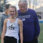 Lake Washington High senior runner Thayer Davis checks out her personal record time of 12.63 seconds in the 100-meter dash on the time board along with coach Roger Hansen on April 3. She won the race and is first in 3A KingCo with that mark. Andy Nystrom / staff photo