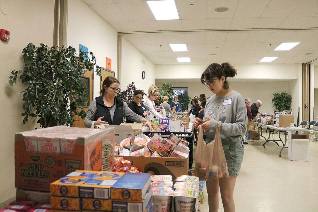 Church members assembled Pantry Packs that were given to the Lake Washington school District for children living in poverty. Stephanie Quiroz/staff photo
