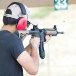 A man shoots an AR-15 at a gun range. Photo courtesy of Avery Bristol/Flickr