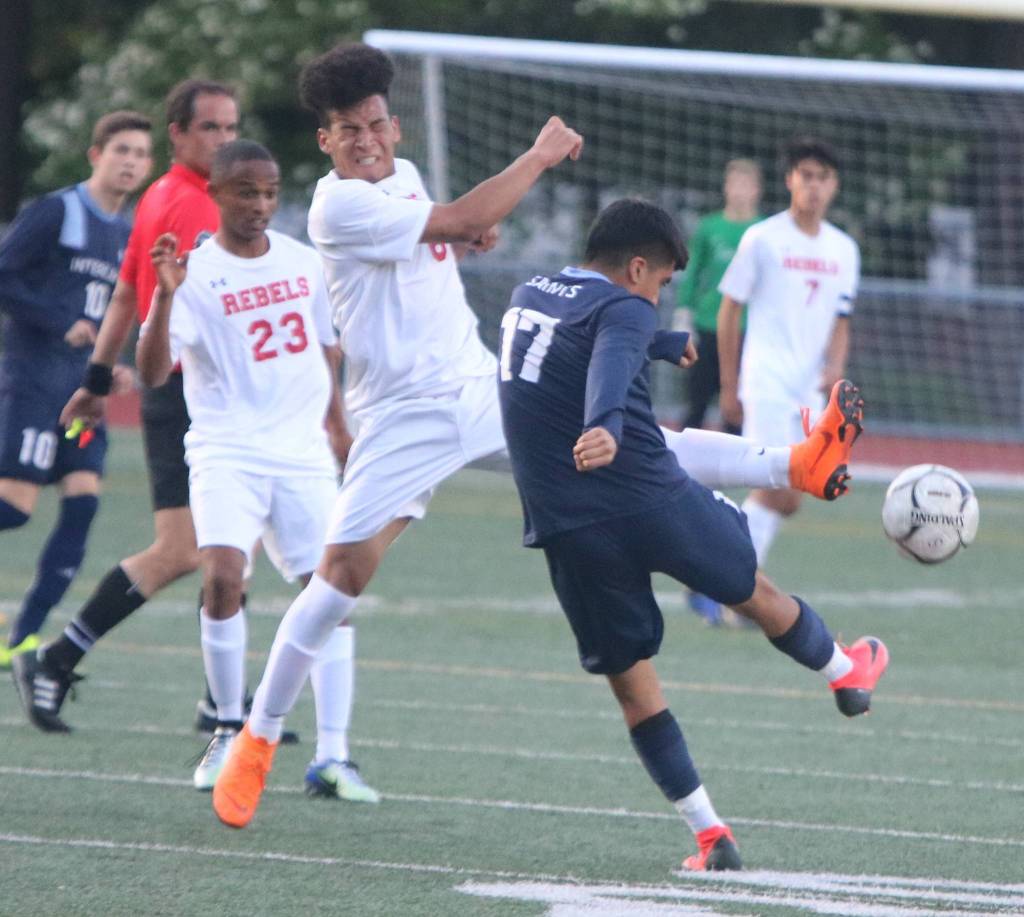 Juanita sophomore Victor Ramos Aguilar, second from left, attempts to halt a pass from Interlake senior Brandon Lazo Gutierrez. Andy Nystrom / staff photo