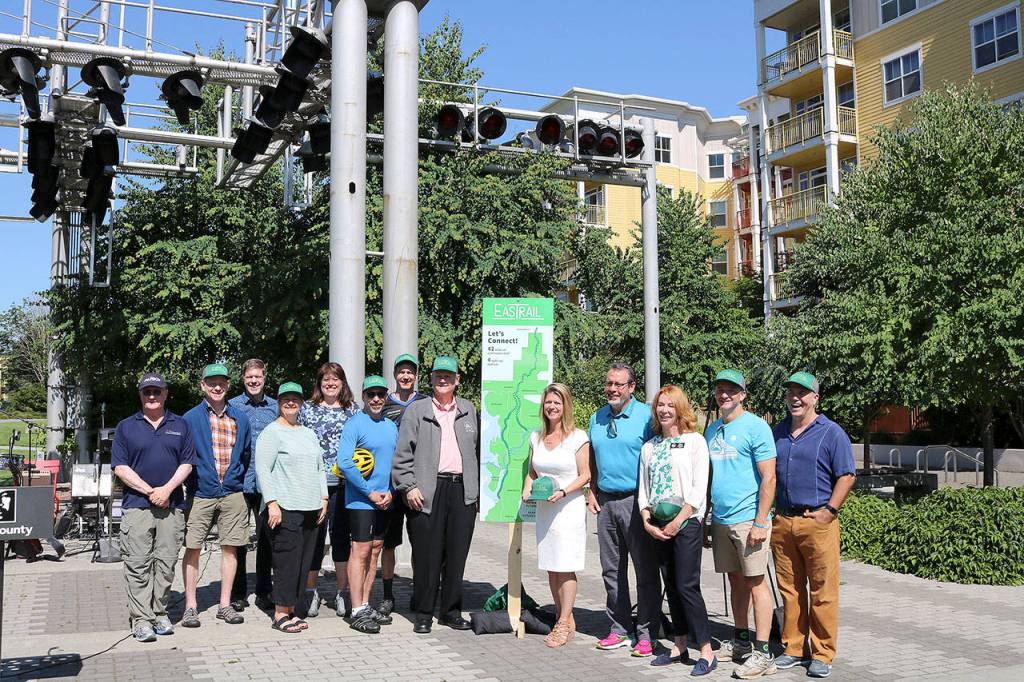 Elected officials, and community leaders from Redmond, Kirkland, Bellevue and King County, and Eastrail Partners unveiled the new name for Eastside Rail on July 20. Stephanie Quiroz/staff photo