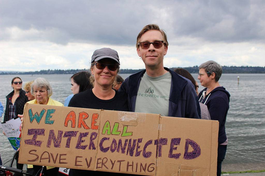 Karen Richards and Matt Armstrong held a sign that says We are all interconnected. Save everything at Fridays climate strike. Madison Miller/staff photo