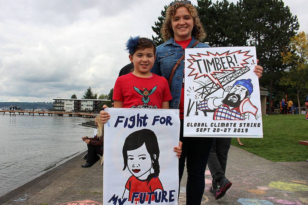 350 Eastside climate organizer, Sara Papanikolaou and her 8-year-old daughter, Tess Papanikolaou, protest at Fridays climate strike. Madison Miller/staff photo