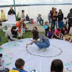 Madison Miller/staff photo                                Amelia Hawkins leads the kids in painting a donated parachute at Fridays climate strike.