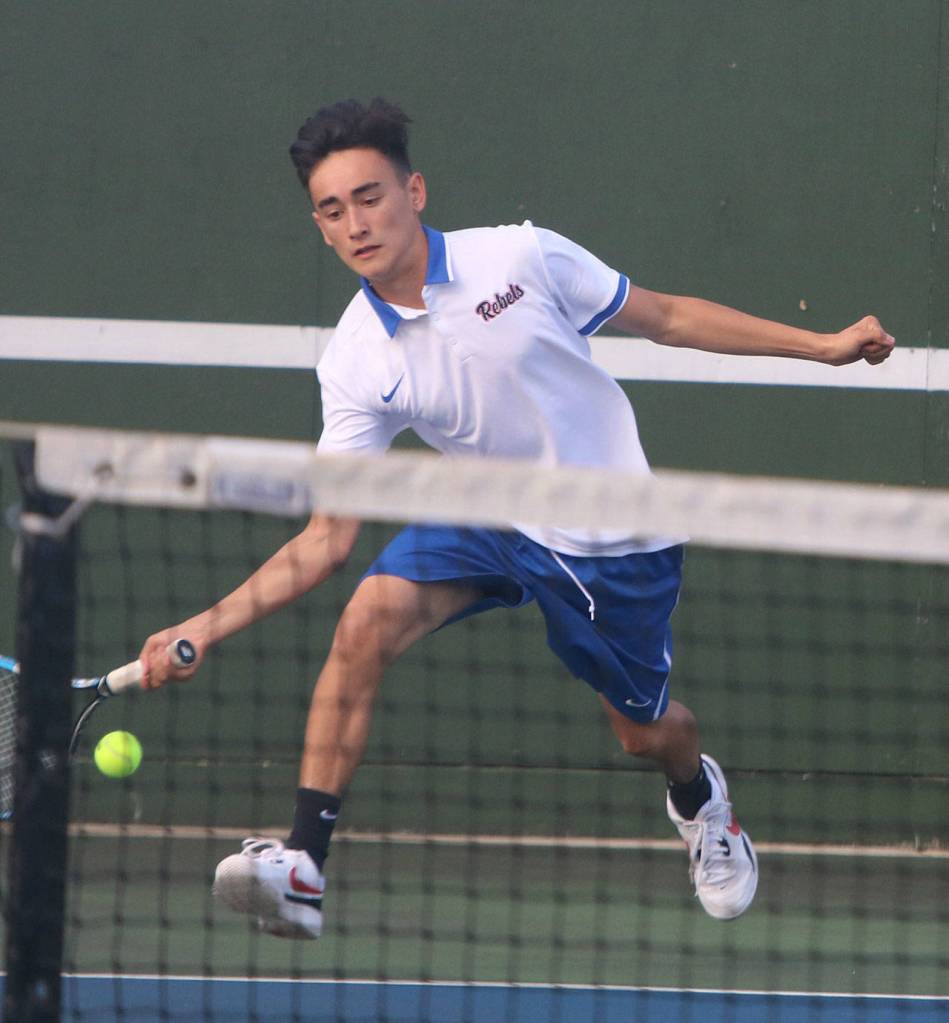 Juanitas Jake Haas reaches for a ball in a No. 2 singles match against Lake Washington. Andy Nystrom/ staff photo