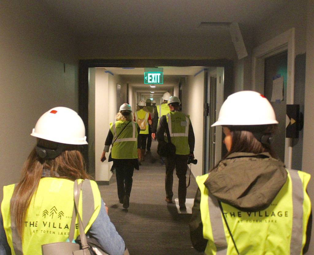 Tour group members view progress on the residential units that will soon be offered by The Village at Totem Lake. Blake Peterson/staff photo