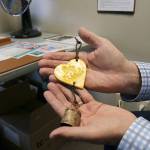 Stephanie Quiroz/staff photo                                Paul Brown looks at his Be Kind bell he received following the Marysville Pilchuck High School shooting.