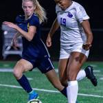 Lake Washington defender Ari Issa (19) runs alongside Bellevue midfielder Kaatje Justus (5) in a 2-0 Kangaroos win on Oct. 15. Photo courtesy of Stephanie Ault Justus