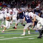 Juanita running back Brayden Brown runs for a 7-yard touchdown in the Rebels 21-8 victory over Interlake on Oct. 18. Benjamin Olson/staff photo