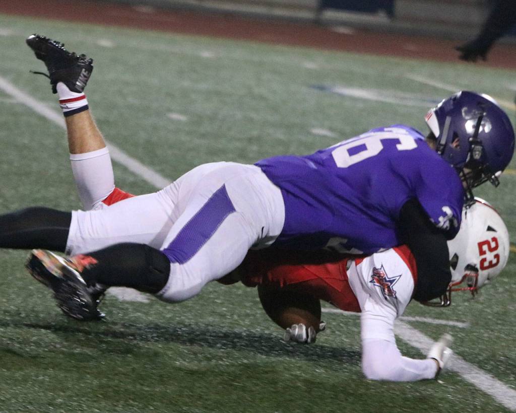 Lake Washingtons Kobe Schilling-George wraps up Juanitas Jackson Byrne. Andy Nystrom/ staff photo