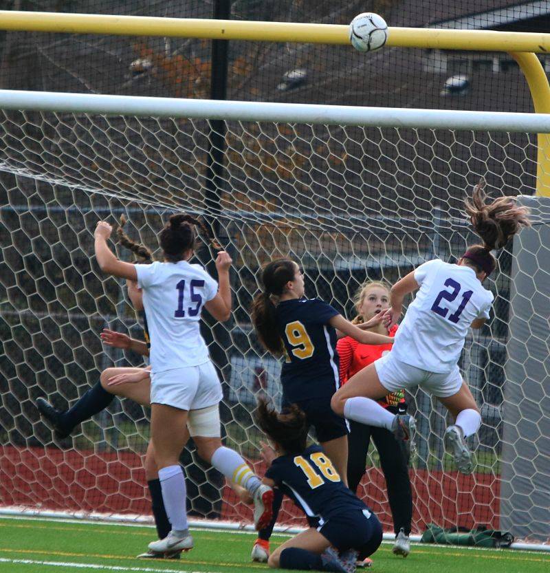 Alex Mueller (15) and Kylie Jones (21) attack the net. Andy Nystrom/ staff photo