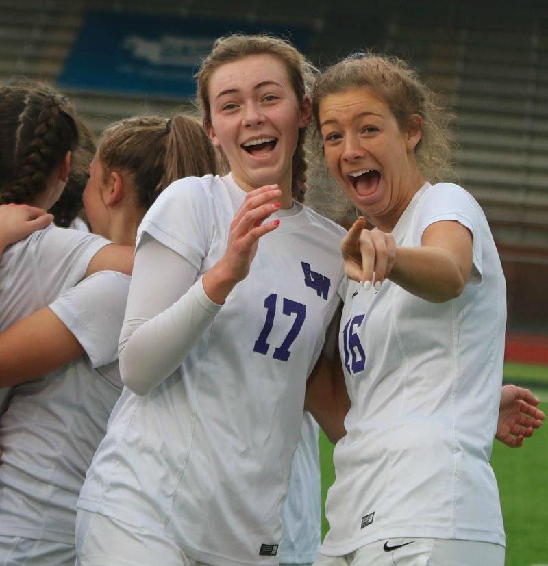Bella Davis, left, and Emma Eschbach celebrate the Kangs state title. Andy Nystrom/ staff photo