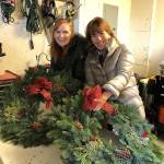 Volunteers from ParentMap join the women of the Terese Smith Howard heritage circle to help tie bows to the wreaths and prepare them for selling. Photo courtesy of Maureen Taasin