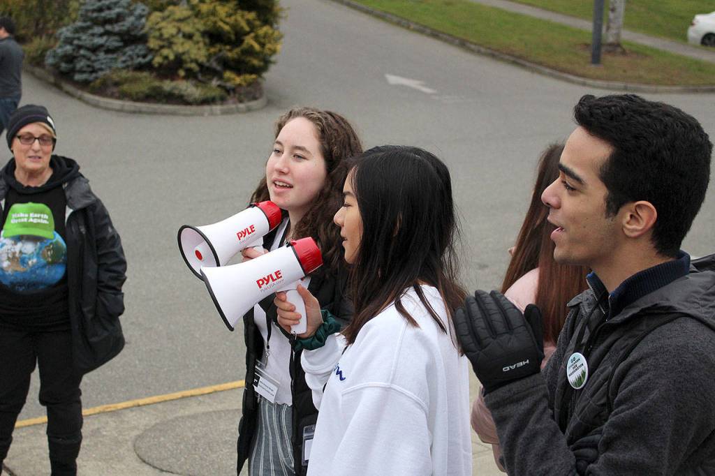 Jolie Simone Barga, Victoria Hsieh and Pouya Souri shout chants at Kirkland City Hall on Dec. 6. Madison Miller / staff photo