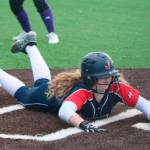 Juanitas Abbie Reynolds slides in safe at home during the district tournament. Andy Nystrom/ staff photo