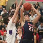 Juanitas Beckham Lie (right) reaches toward the hoop as Lake Washingtons Jackson Pribic defends during the Kangs 52-43 boys basketball victory on Feb. 7. LW led 39-28 after three quarters and Juanita cut the Kangs lead to 40-35 with 6:16 left in the game. LW pulled away from there to secure the victory. Andy Nystrom/ staff photo