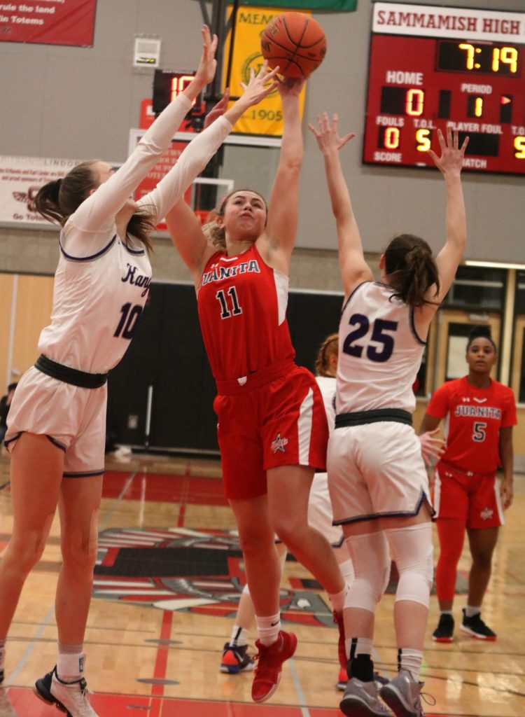 Juanitas Madi Kisker attacks the hoop against LWs Elise Hani, left, and Rosa Smith. Andy Nystrom/ staff photo