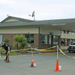 A security guard positions cones as he stands watch in front of the Econo Lodge-turned-coronavirus-quarantine site on Central Avenue North on Tuesday. King County personnel were on site preparing the motel. MARK KLAAS, Kent Reporter