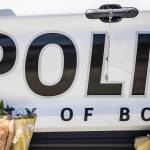 A rosary hangs from a Bothell Police Department vehicle door handle on Tuesday in Bothell. (Olivia Vanni / The Herald)