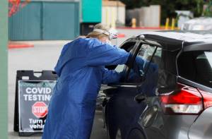 Licensed practical nurse administers a COVID-19 test at the Jamestown Family Clinics drive-up testing site on Dec. 7. Sequim Gazette photo by Michael Dashiell