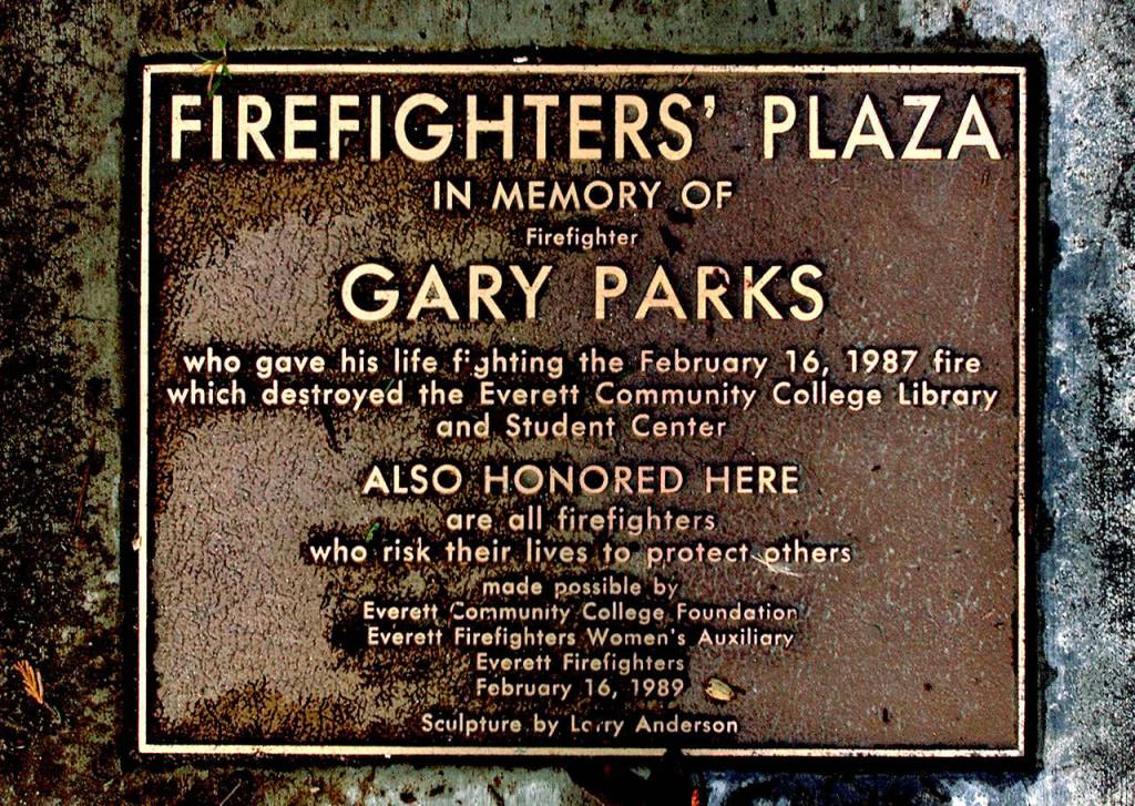 A bronze plaque is fixed in the walkway at the Gary Parks memorial outside the Everett Community College library. (Dan Bates / Herald file)