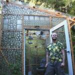 Axton Burton stands proudly in front of the greenhouse he made in his parents yard in Duvall, Wash. (photo by Cameron Sheppard)