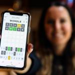 Christa Meyer, 41, a home health physical therapist, plays Wordle daily at her Mountlake Terrace home or on her lunch break between patients in her car. (Kevin Clark / The Herald)