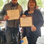 Two members show off their Everyday Hero awards. Courtesy of Kiwanis Club Kirkland.