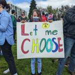 A young girl holds a sign saying Let me choose during a reproductive rights protest at Cal Anderson Park on May 14, 2022. Hannah Saunders/Sound Publishing