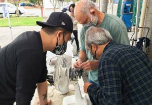Volunteer fixers attempt to repair a fan at one of King countys 2021 repair events. Photo courtesy of King County Solid Waste Division.