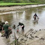 Trapping European Green Crabs. From left to right, WDFW staff Nate Goldschmidt and Lindsey Parker, and Veteran Corps intern Johnathan Hallenbeck. Photo courtesy of Chase Gunnell.