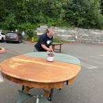 Angela Bayler painting a table at the Furniture Fix-it Fair. Photo courtesy of Xenia Dolovova.