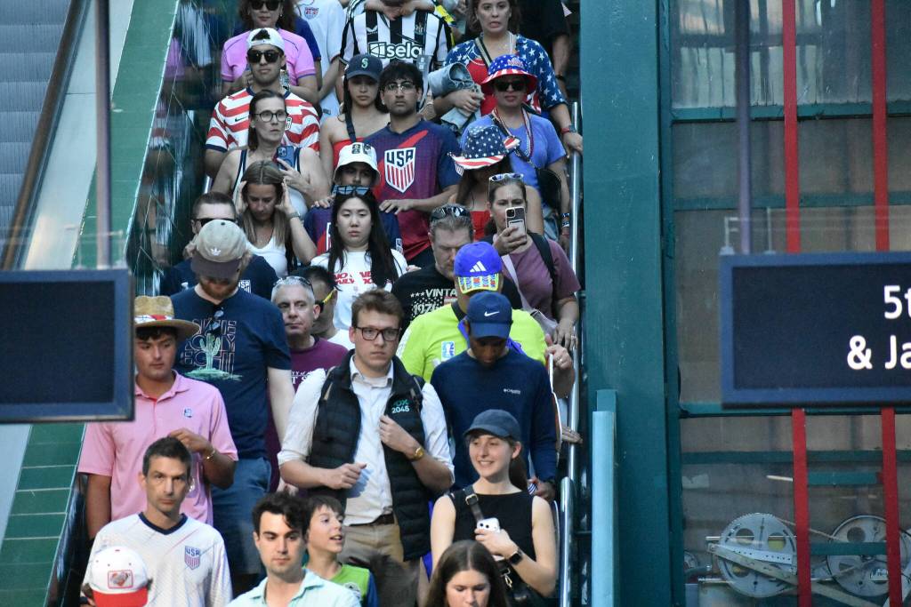 Fans pack the stairs heading to the light rail train at International District. Ben Ray / The Reporter